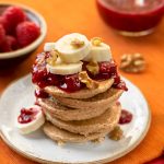 Banana Oat Pancakes with walnuts & raspberry sauce