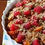 Vegan unbaked peach crumble with berries