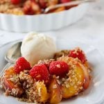 Vegan unbaked peach crumble with berries