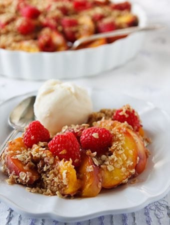 Vegan unbaked peach crumble with berries