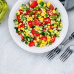 Fresh Summer Corn and tomato saldSalad Bowl With Tomatoes, Cucumbers, Red Onions And Parsley.