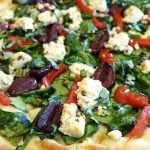 Greek pizza with spinach, peppers, and vegan feta