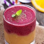 Layered mango or peach and berry smoothie