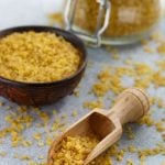 Uncooked Bulgur in scoop, bowl, and jar