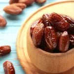 dried dates in a wooden bowl