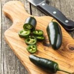 Sliced jalapeno pepper on cutting board